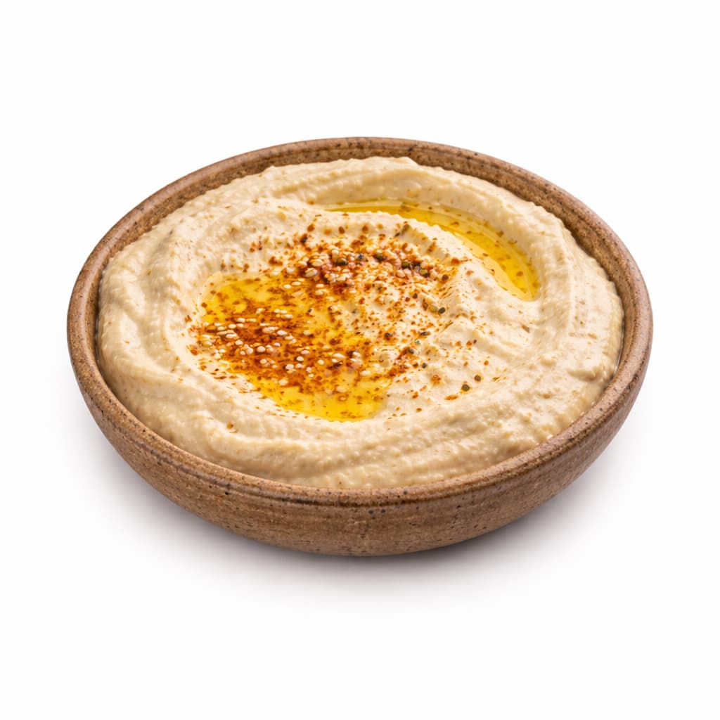Houmous libanais crémeux dans un bol avec huile d’olive, spécialité mezze libanais à Paris